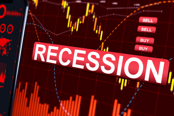 A stock market display with the word recession on it.