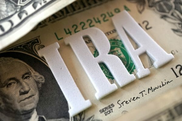 The word IRA is spelled out on a dollar bill.