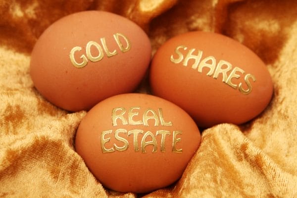 Three eggs with the words gold shares real estate written on them.